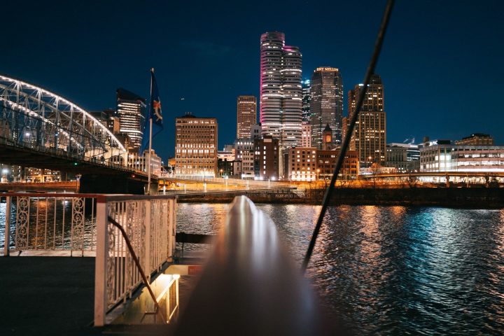 a bridge over a body of water with a city in the background