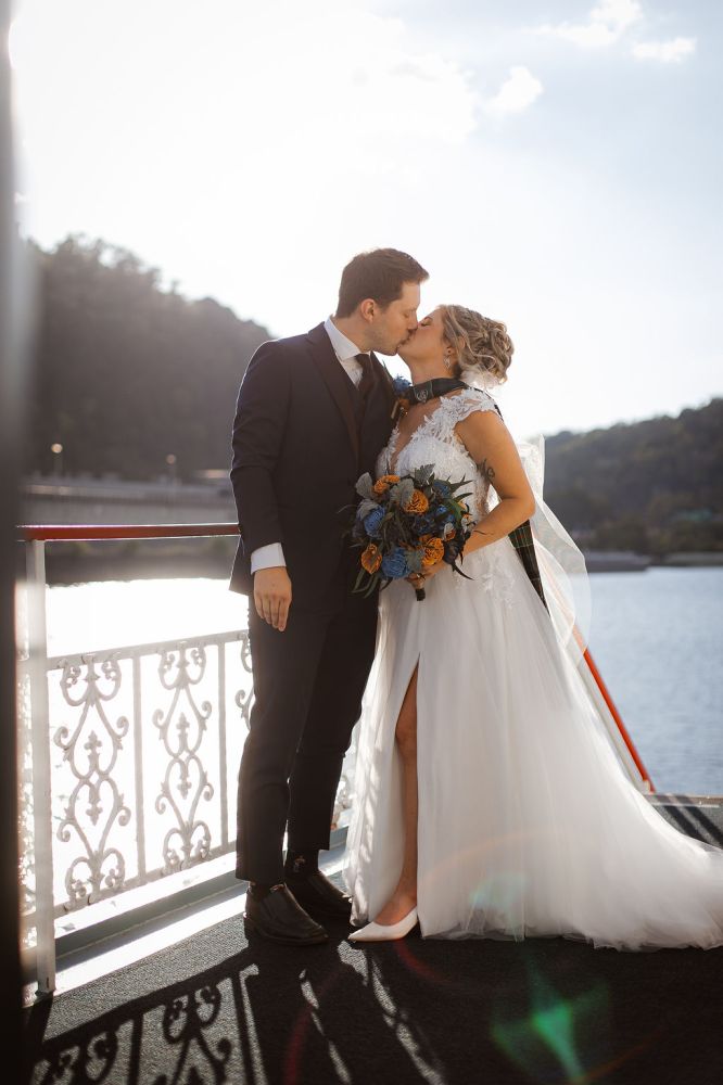 a man and a woman standing in front of water